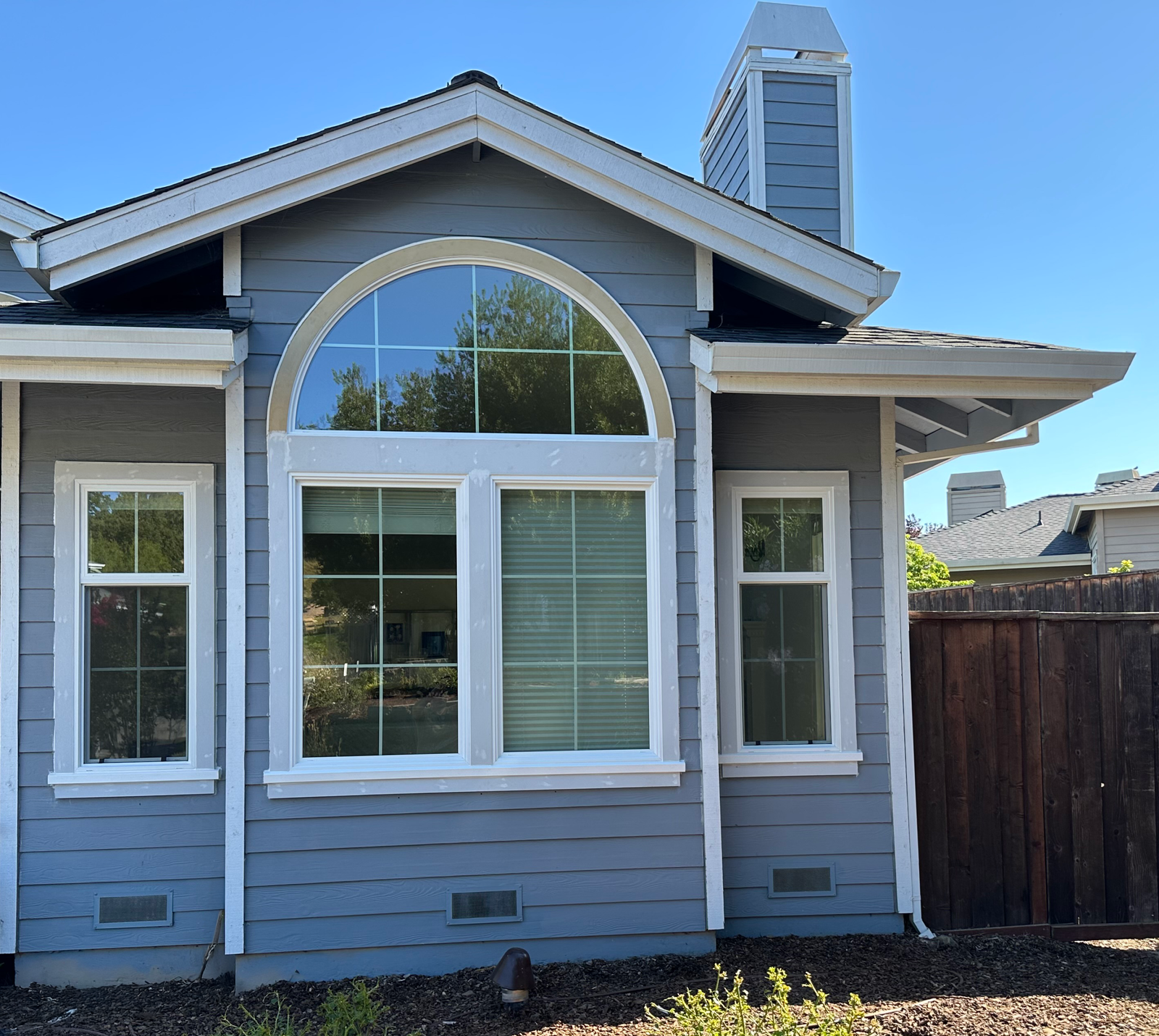 Craftsman home with new arched picture window and double-hung windows, East Bay