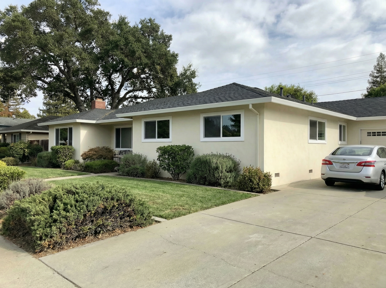 After: same ranch home with new double-pane vinyl windows
