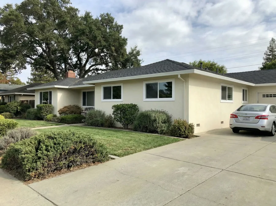 After: same ranch home with new double-pane vinyl windows