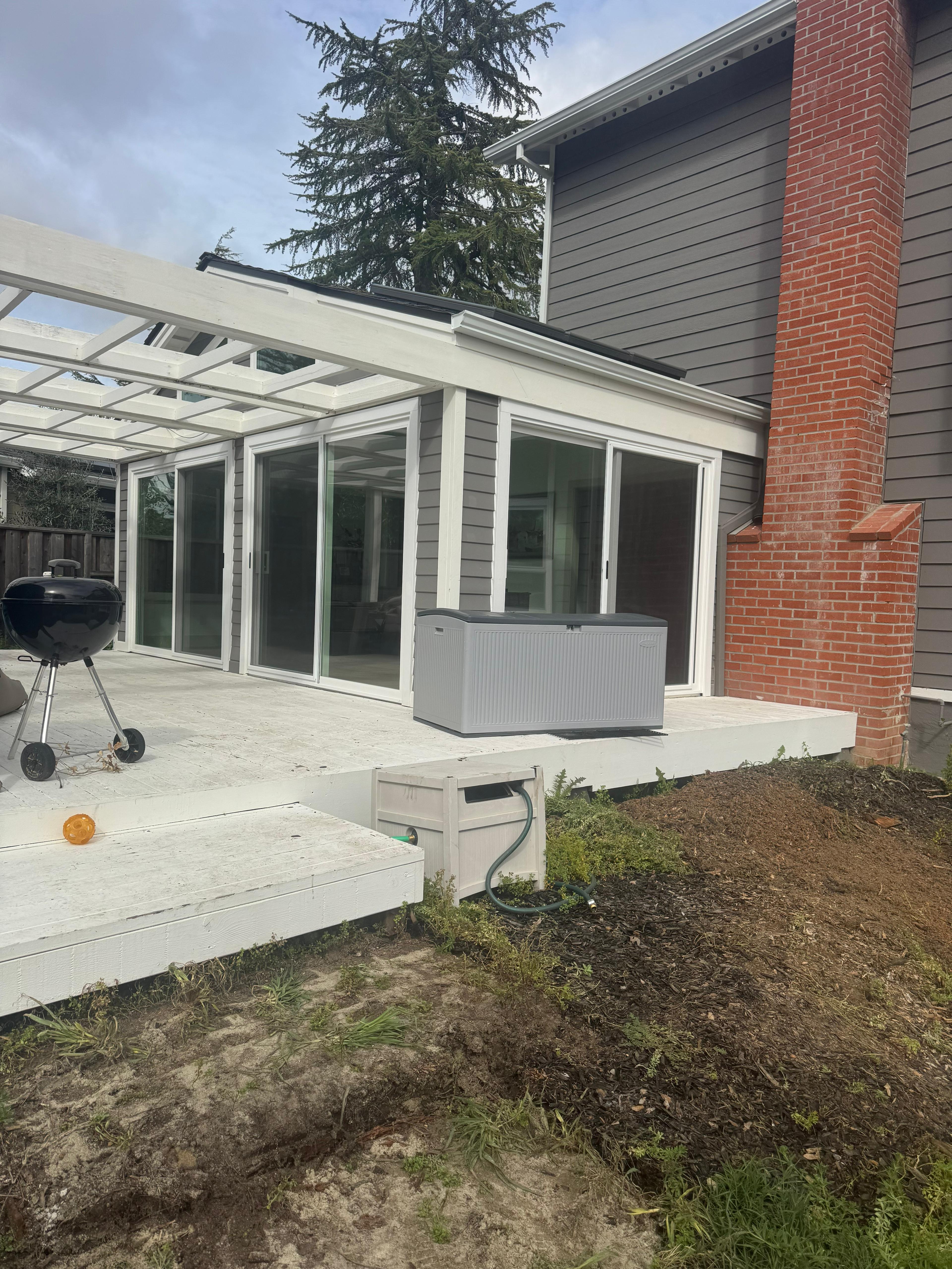 Large aluminum multi-panel sliding door system on patio, East Bay