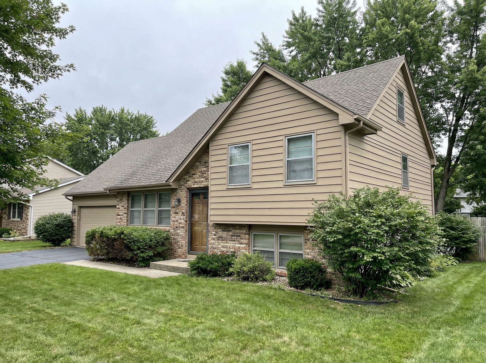 Before: two-story home with original single-pane windows