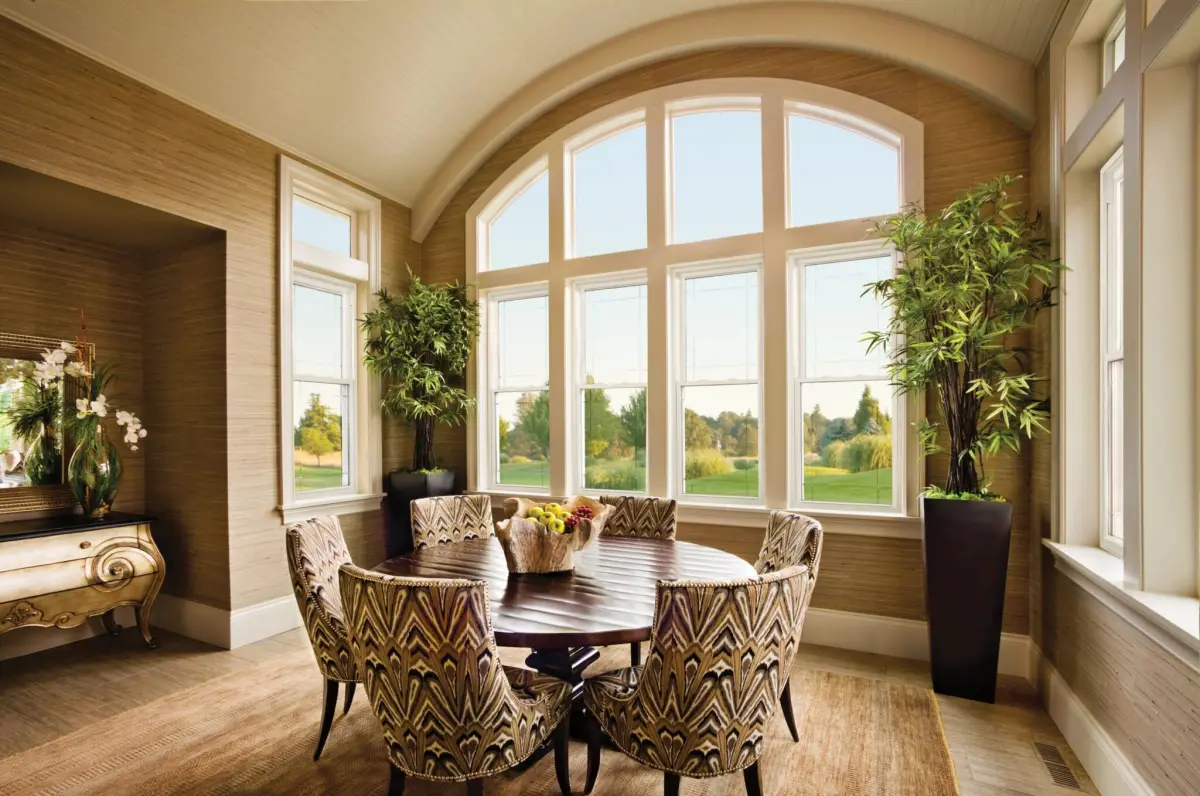 Breakfast nook with arched windows over picture windows