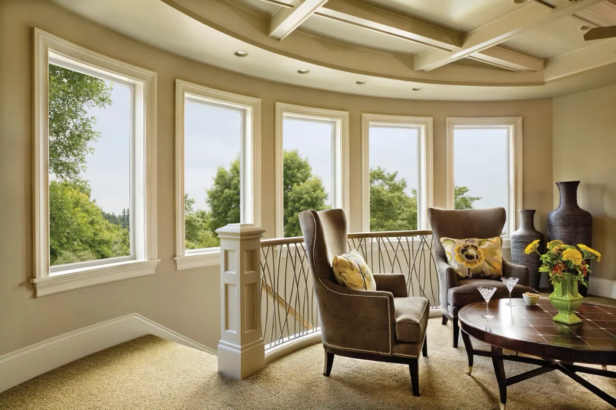 Curved sitting room lined with Alside Mezzo windows