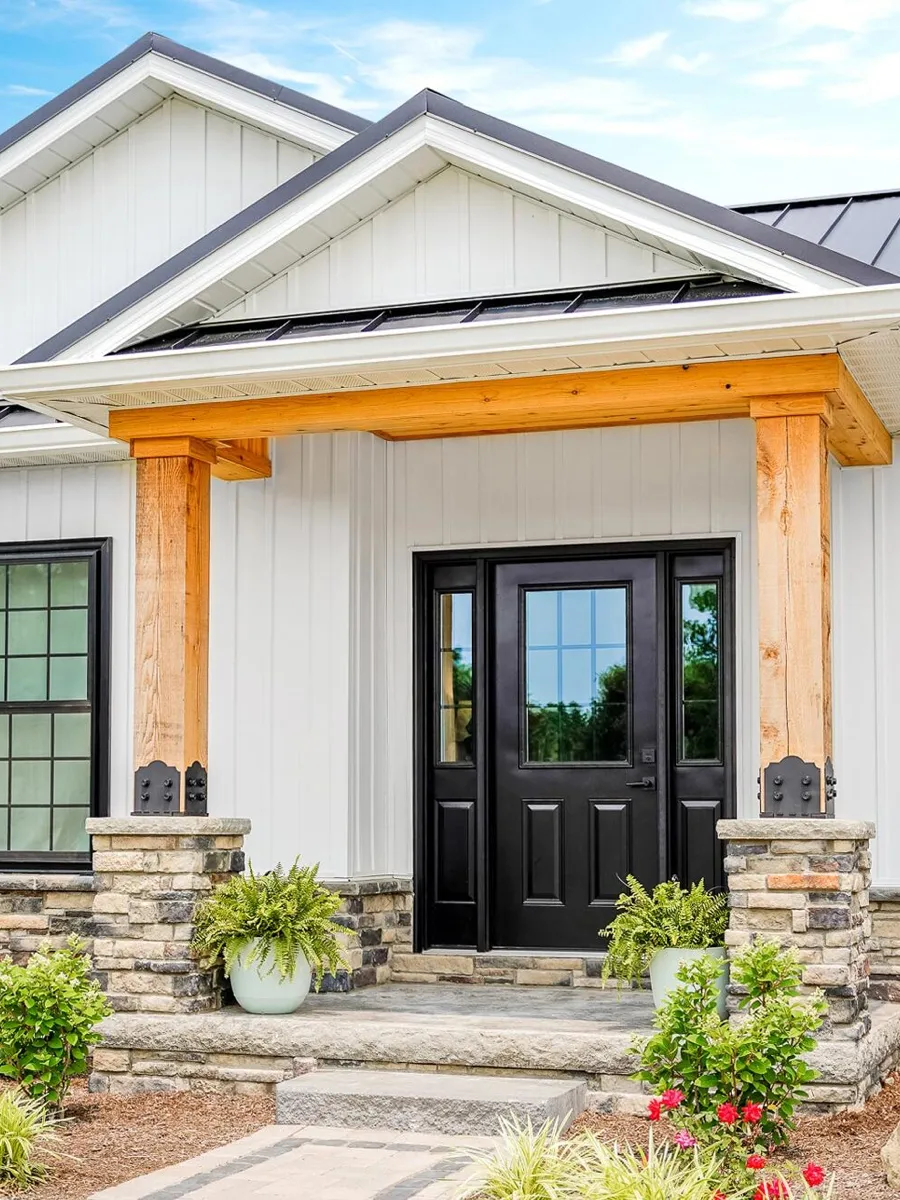Farmhouse porch with a black ProVia Legacy steel entry door