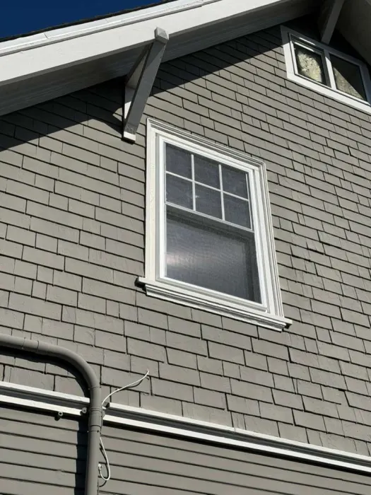 Single hung window with grilles installed on gray shingle craftsman home, East Bay