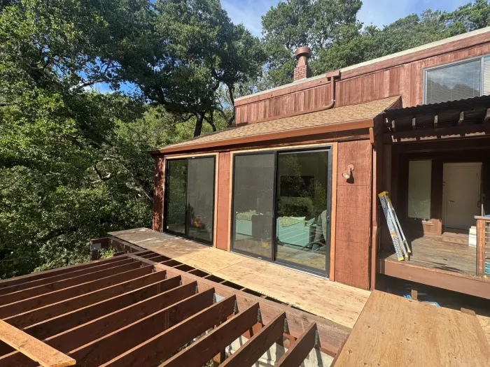 Aluminum sliding glass door on wood deck, East Bay