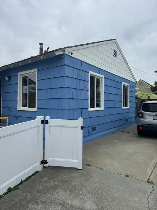 Complete window replacement package on blue shingle craftsman home, East Bay