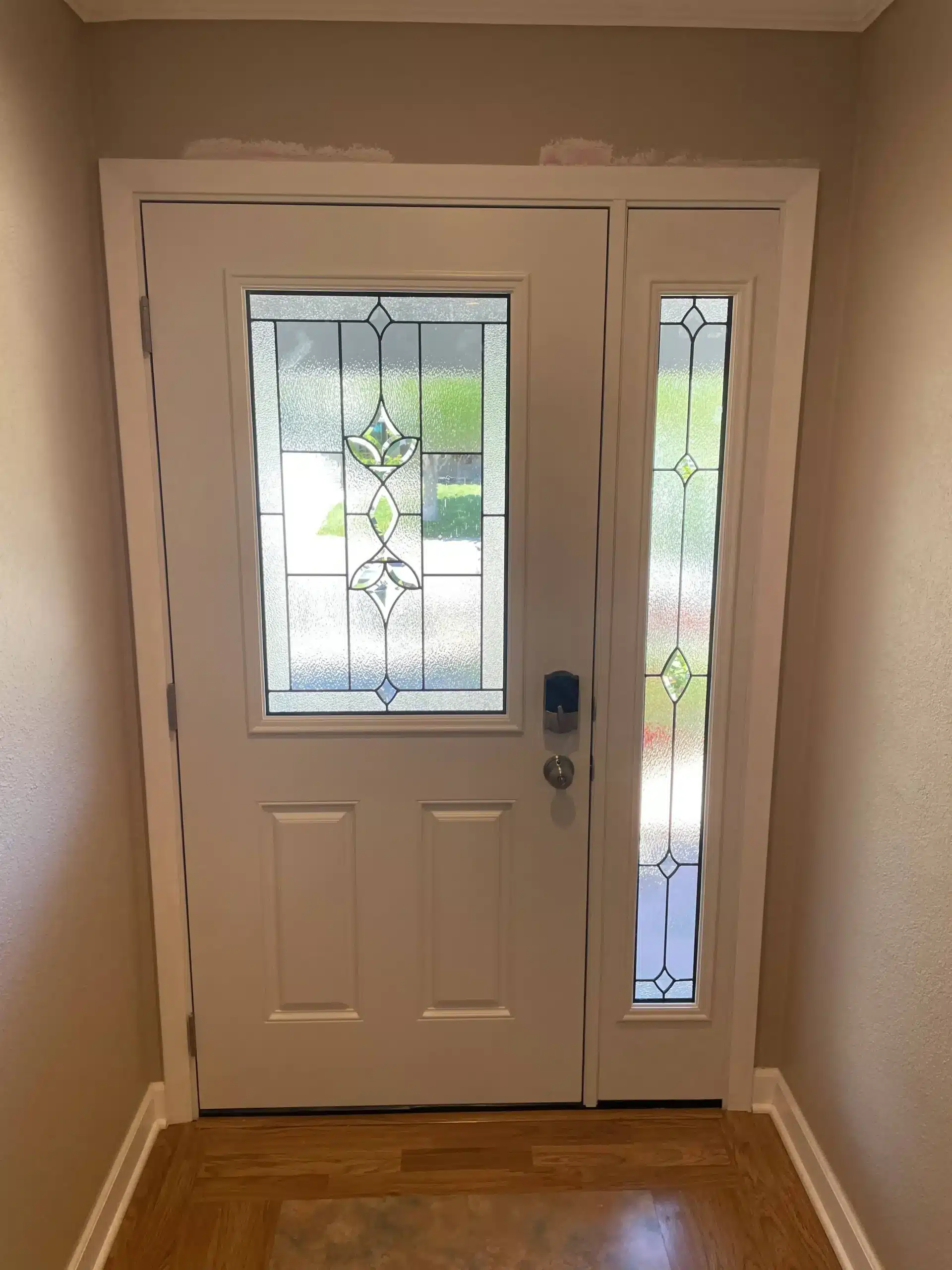 Entry door with decorative glass installed by Windows 4U