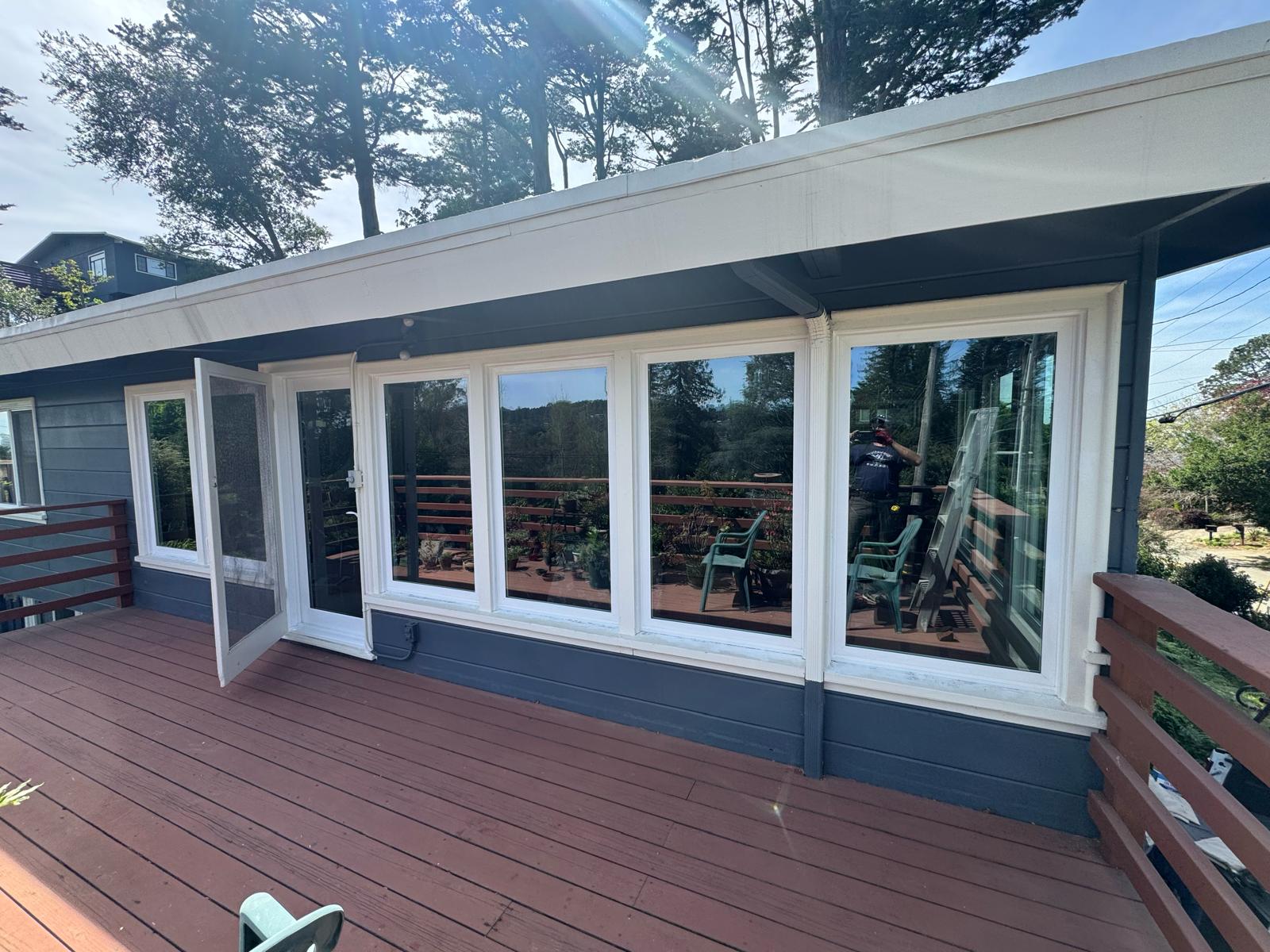 Vinyl picture windows installed on deck-facing wall, East Bay