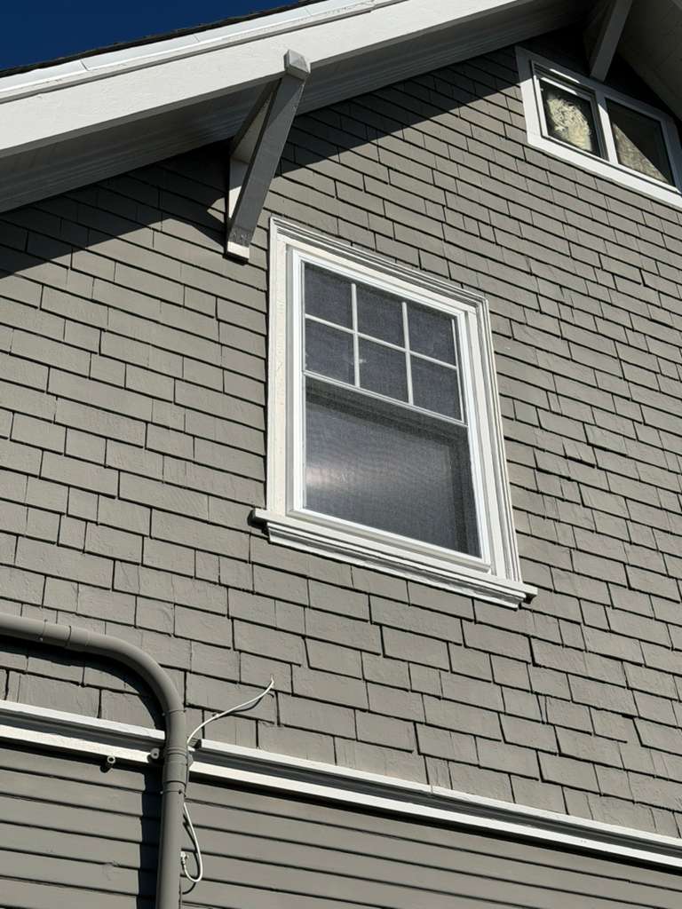 Single hung window with grilles installed on gray shingle craftsman home, East Bay