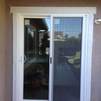 New sliding patio door installed on beige stucco home exterior, East Bay
